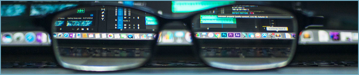 glasses with a desktop dock visible through them showing adobe and web development product icons